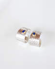 Reptilia silver textured earrings with blue natural stone (lapis lazuli), front view.