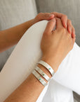 Model wearing the Reptilia Minima vermeil cuff with natural gemstone, on-wrist.