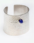 Reptilia Maxima silver cuff with blue chalcedony cabochon set in 18k gold, angled front view.