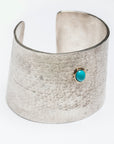 Reptilia Maxima silver cuff with turquoise cabochon, angled front view.