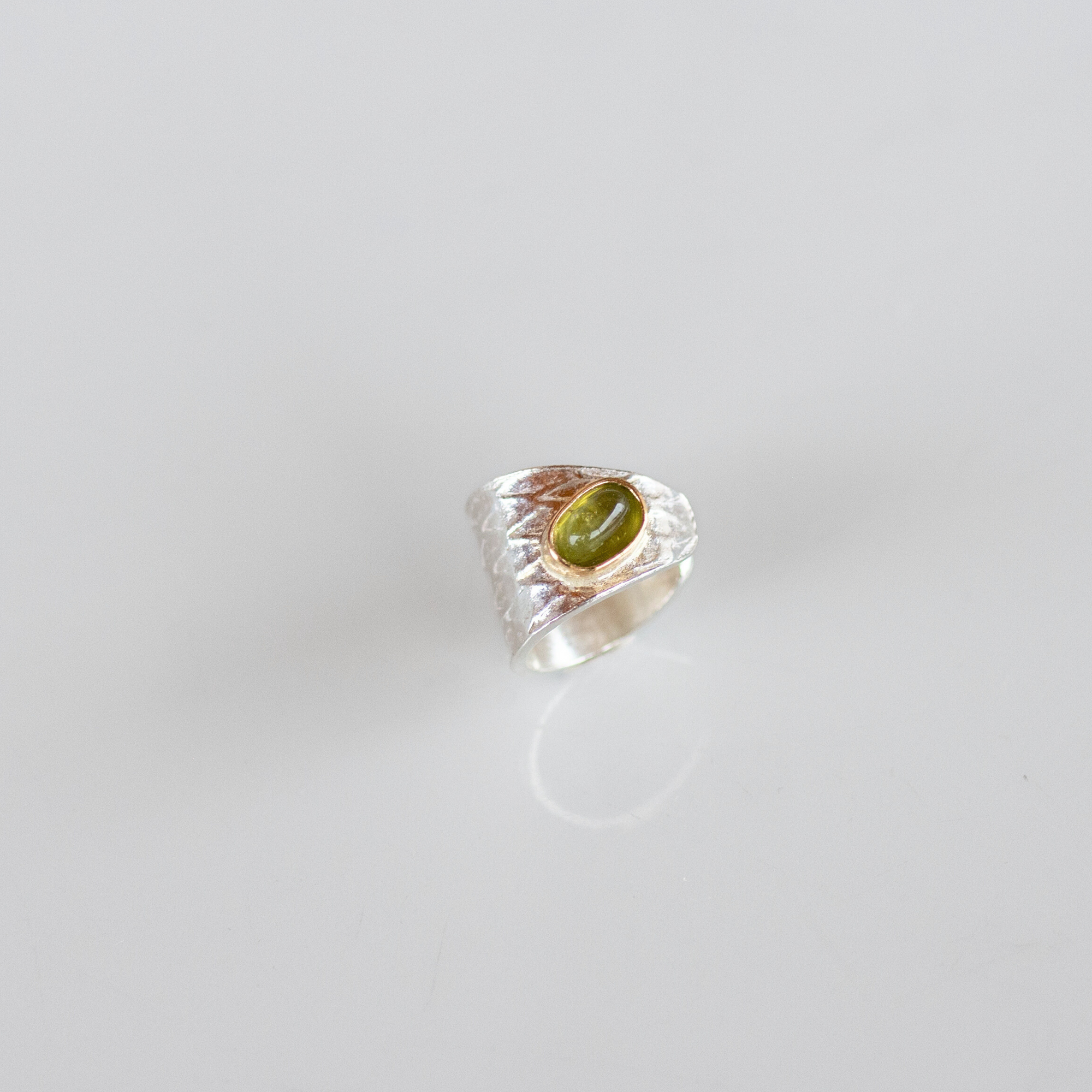 Reptilia silver earcuff with natural gemstone, finish and texture detail.